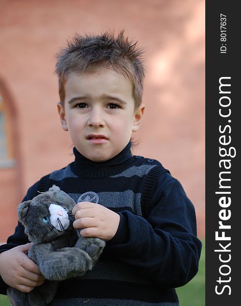 Boy with a toy kitten