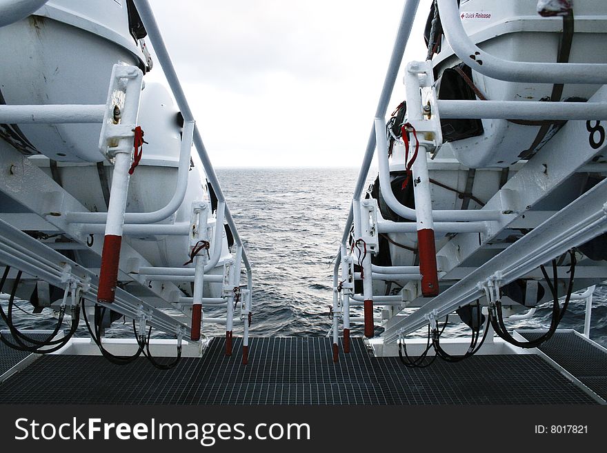 A row of life rafts arranged and ready to use on a large passenger ship