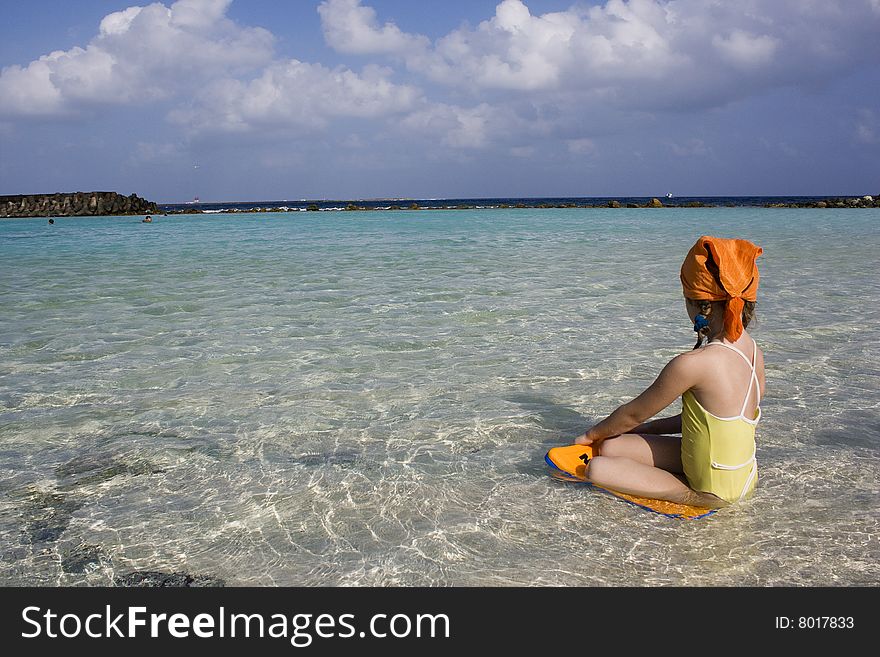 Small girl on the beach looking to the ocean. Small girl on the beach looking to the ocean