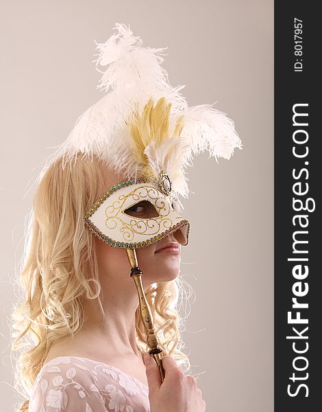 Beautiful young woman with Venetian mask, studio photo. Beautiful young woman with Venetian mask, studio photo