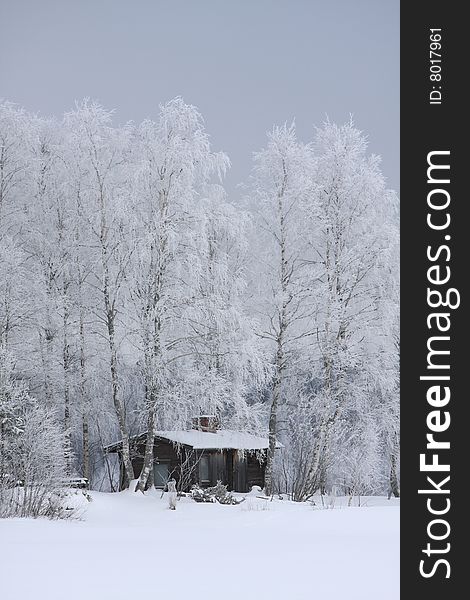 Wooden house in winter in a forest scenery, Finland