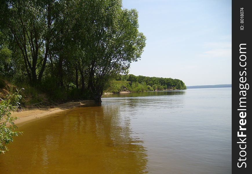 River with trees on background sky