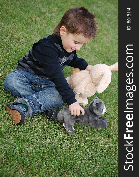 Little boy with a toy hare in hands. Little boy with a toy hare in hands