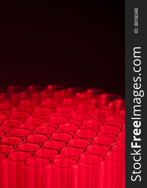 Shallow focus close-up of empty glass test tubes in red. Shallow focus close-up of empty glass test tubes in red