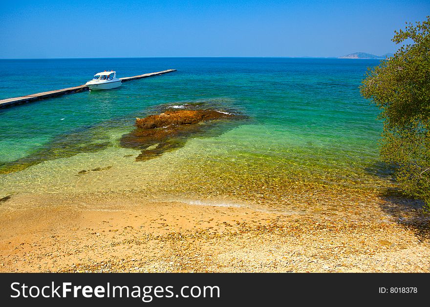 Boat at the berth, clear sea