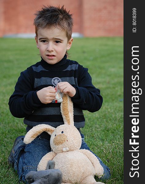 Little boy with a toy hare in hands. Little boy with a toy hare in hands