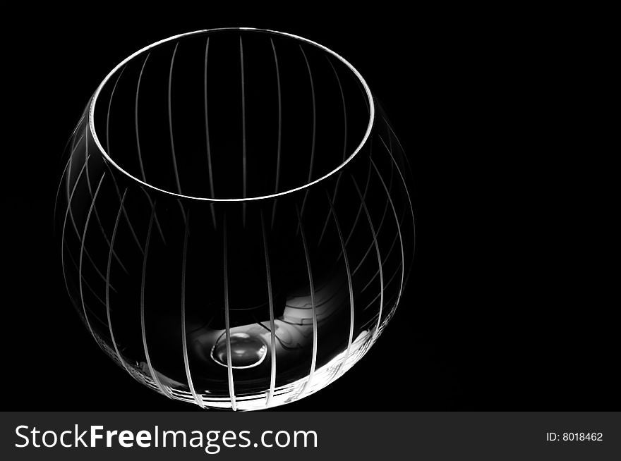 Luxury crystal globe wine glass isolated on a black background with copy space