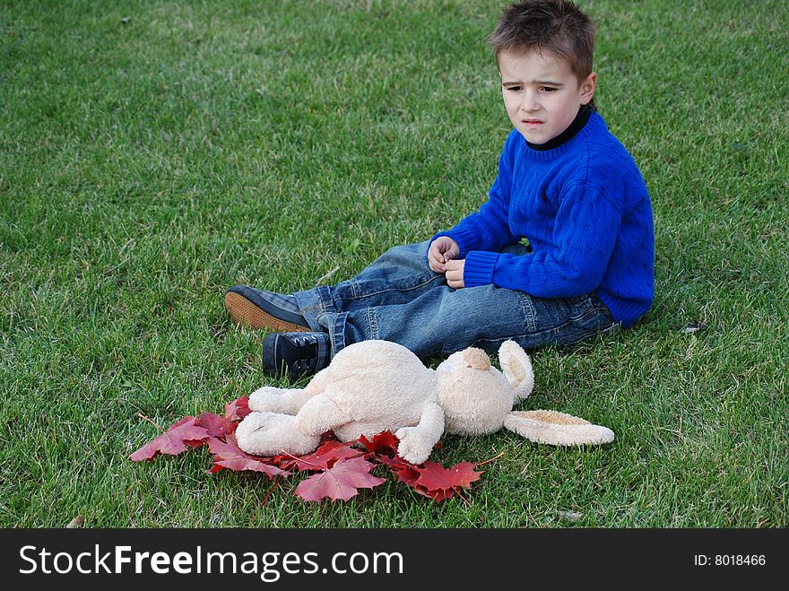 Little boy with a toy hare in hands. Little boy with a toy hare in hands
