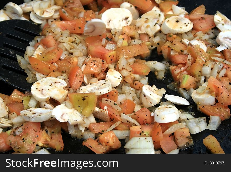 Mushrooms, Onions and tomatoes being stir fried