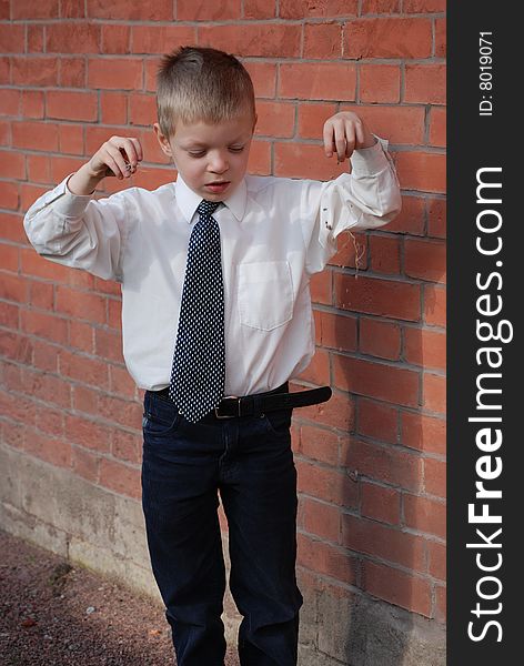 Boy on a background a brick wall