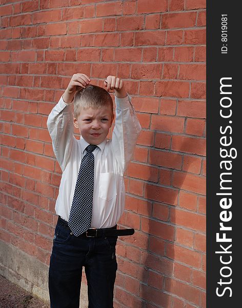 Boy on a background a brick wall