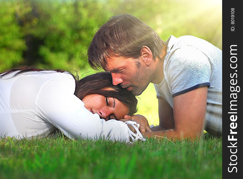Young couple lying on the grass. Young couple lying on the grass