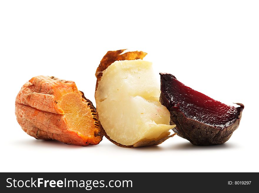 Pieces of grilled vegetables: carrot, beet, potato isolated on a white background.
