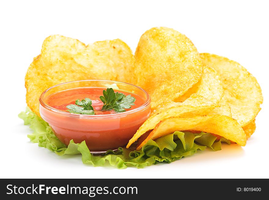 Potato chips and ketchup on a lettuce. Isolated on a white background&