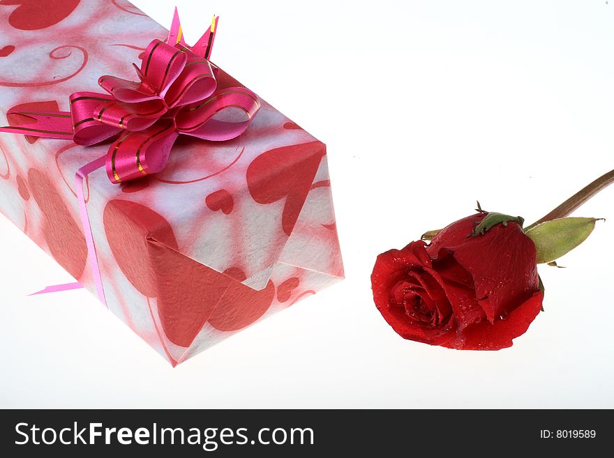Beautiful gift box with a rose on white background. Beautiful gift box with a rose on white background.