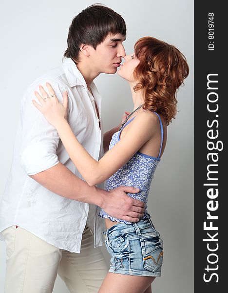 Couple young man and woman kissing on white background