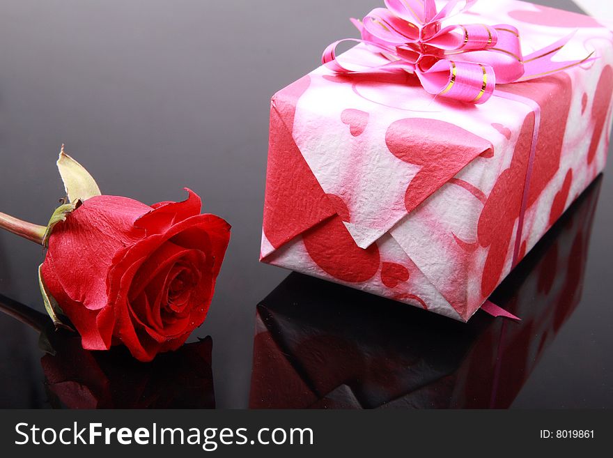 Beautiful gift box with a rose on dark. Beautiful gift box with a rose on dark.