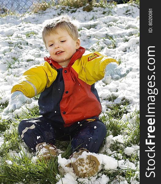 A little boy plays outside in his garden during the heavy snowfall in southern england 2009. A little boy plays outside in his garden during the heavy snowfall in southern england 2009.