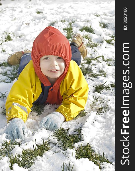 A little boy plays outside in his garden during the heavy snowfall in southern england 2009. A little boy plays outside in his garden during the heavy snowfall in southern england 2009.