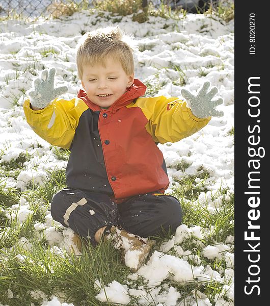 A little boy plays outside in his garden during the heavy snowfall in southern england 2009. A little boy plays outside in his garden during the heavy snowfall in southern england 2009.