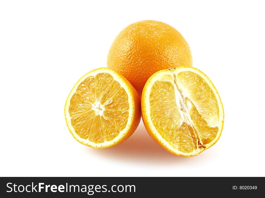 The whole orange and two halves of an orange. On a white background. The whole orange and two halves of an orange. On a white background