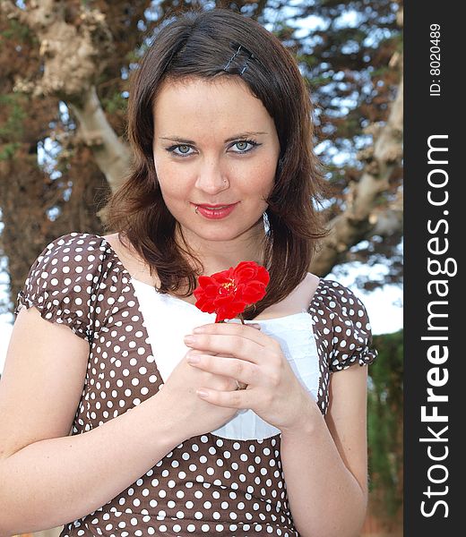 Smiling woman holding a red rose. Smiling woman holding a red rose