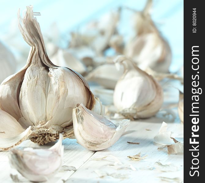 Garlic on white table with blue light from back