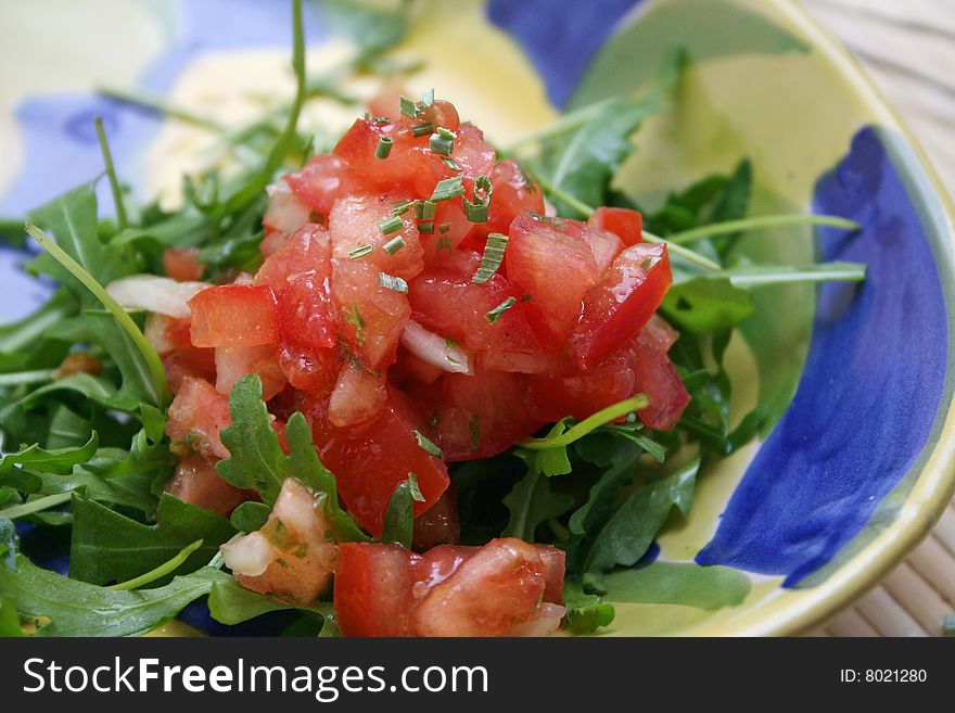 A fresh salad of tomatoes and rucola salad