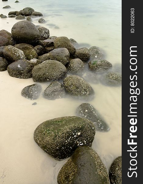 Long exposure of a rocky shoreline at ebbing tide