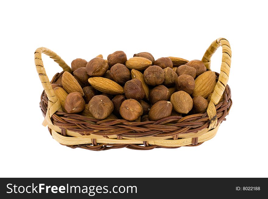 Filbert and almonds in a wum basket isolated on white