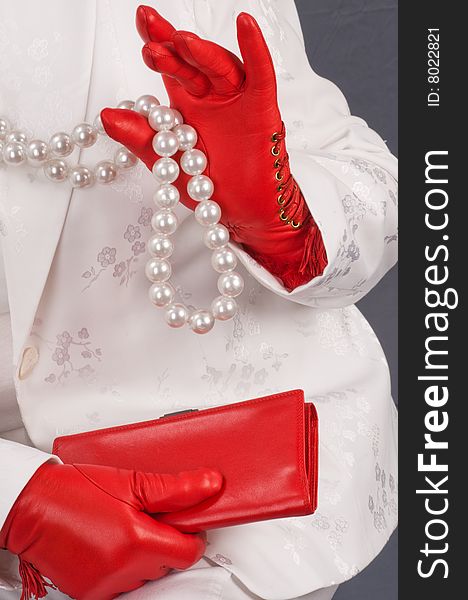 Hands female in red gloves hold a purse. Hands female in red gloves hold a purse.