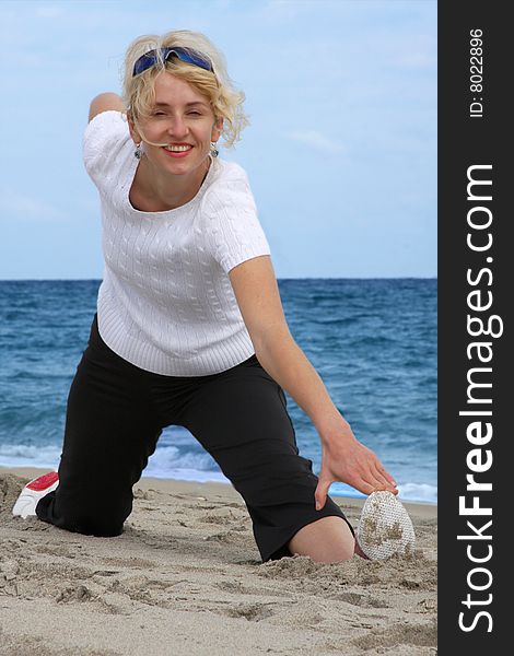 Blond girl exercising at sea beach