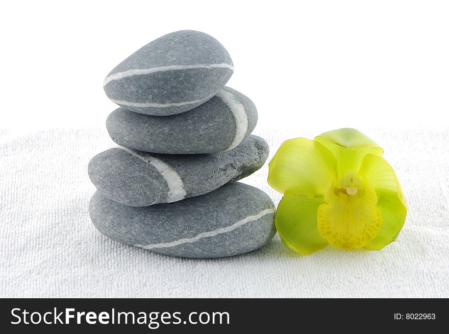 Stacked zen stones with orchid