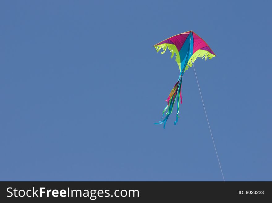 Colored kite in blue sky. Colored kite in blue sky