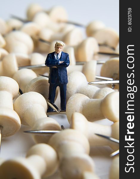 Businessman figurine placed with tacks. Businessman figurine placed with tacks