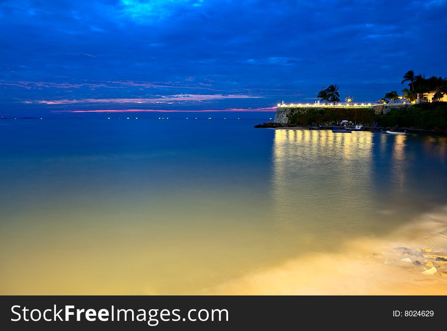 Nightly lights, the sea and hotel on the rock. Nightly lights, the sea and hotel on the rock