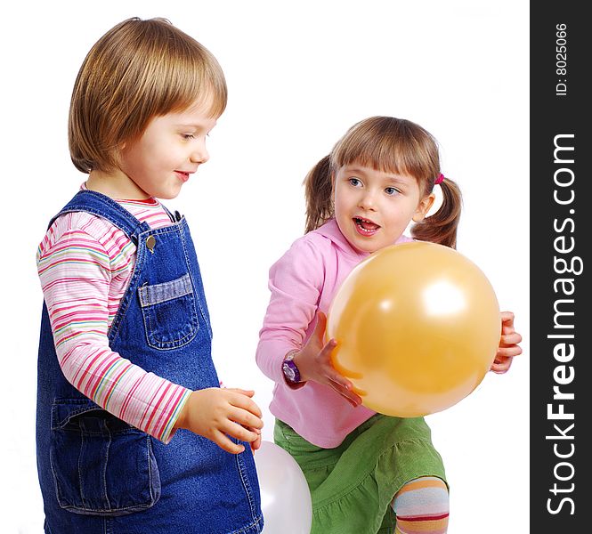 Two girls playing air balloons. studio shot