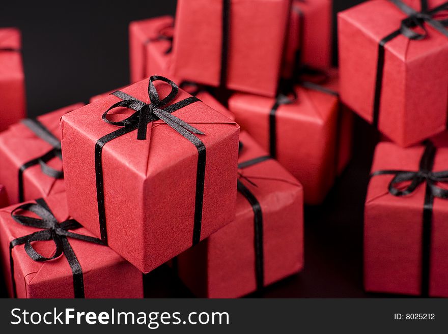 Many red gift boxes on black background
