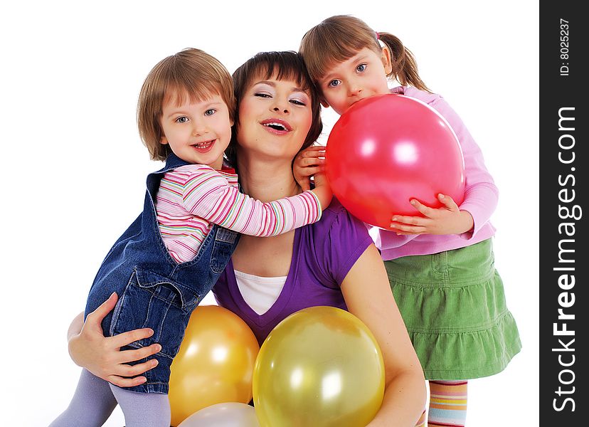 Mother and his two daughters with colorful balloons. studio shoot over white background