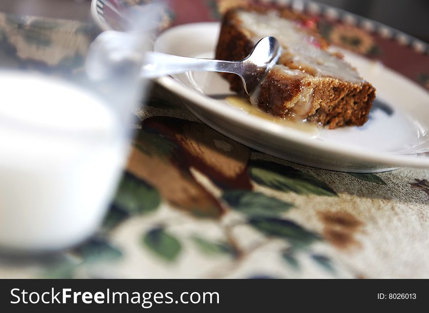 Milk and a fruit cake with selective focus. Milk and a fruit cake with selective focus