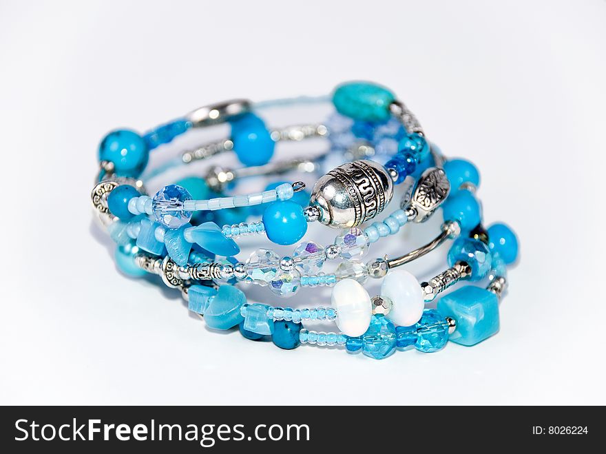 Blue bracelet on white background with turquoise and moonstone