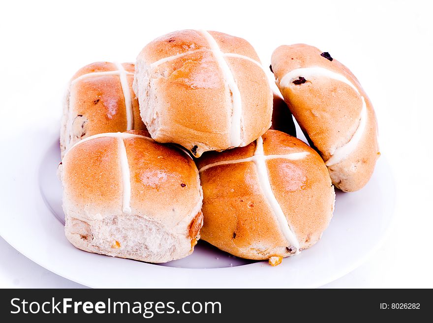 A plateful of fresh hot cross buns. A plateful of fresh hot cross buns