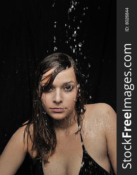 Portrait of woman taking a shower on black background. Portrait of woman taking a shower on black background