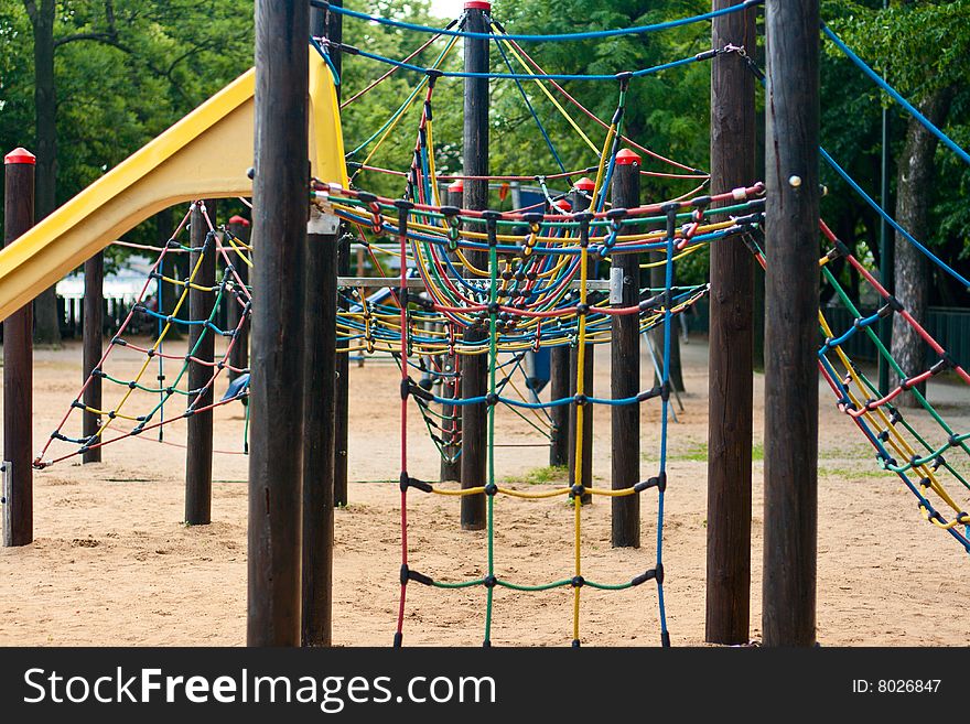 A colorful playground in a park. A lot of coloured ropes. A colorful playground in a park. A lot of coloured ropes.