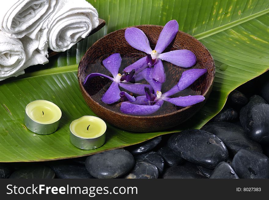 Orchid and stones on banana leaf. Orchid and stones on banana leaf
