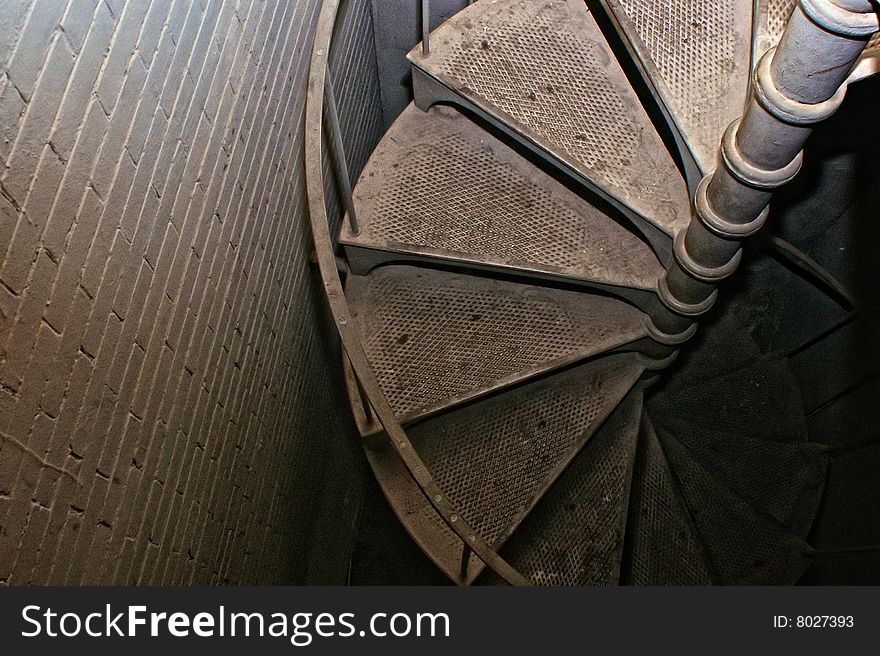 Looking down spiral staircase trailing off into darkness. Looking down spiral staircase trailing off into darkness