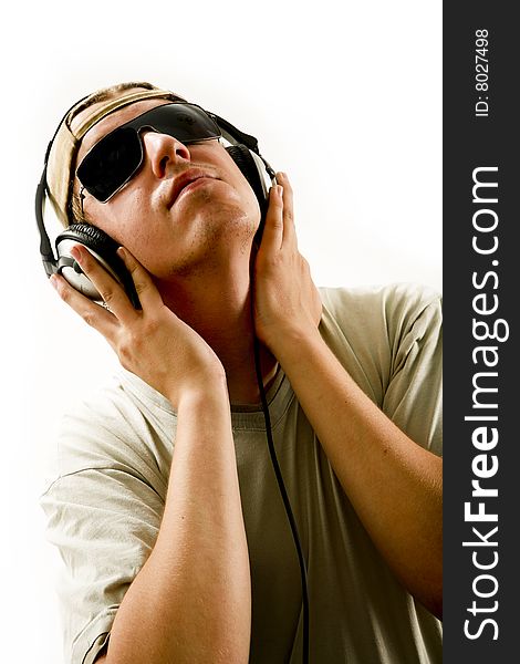 Young beautiful happy man listening music in headphones