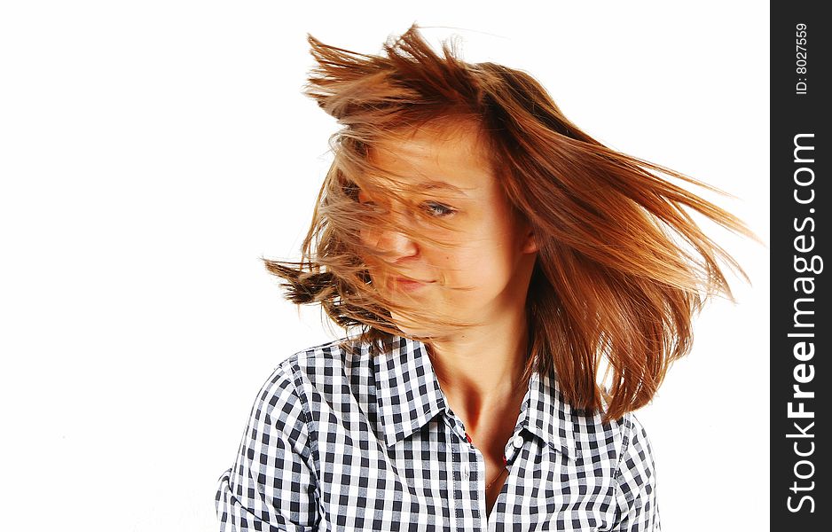 Pretty young woman flinging long hair into air