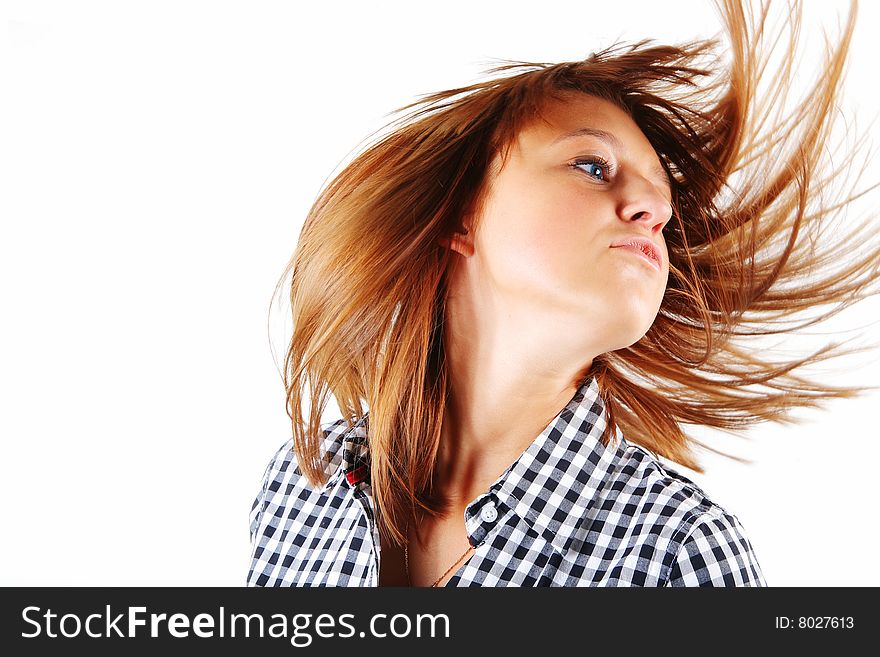 Pretty young woman flinging long hair into air isolated