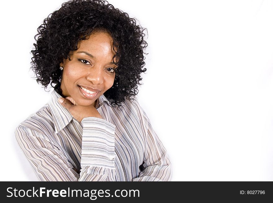 A friendly African American girl smiles at the camera in front of a white background. A friendly African American girl smiles at the camera in front of a white background